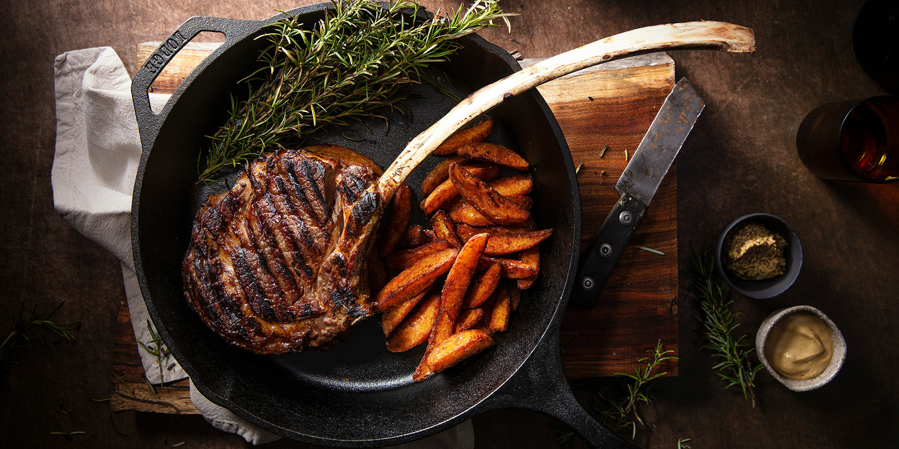 American dish featuring perfectly cooked steak with sides of carrots.