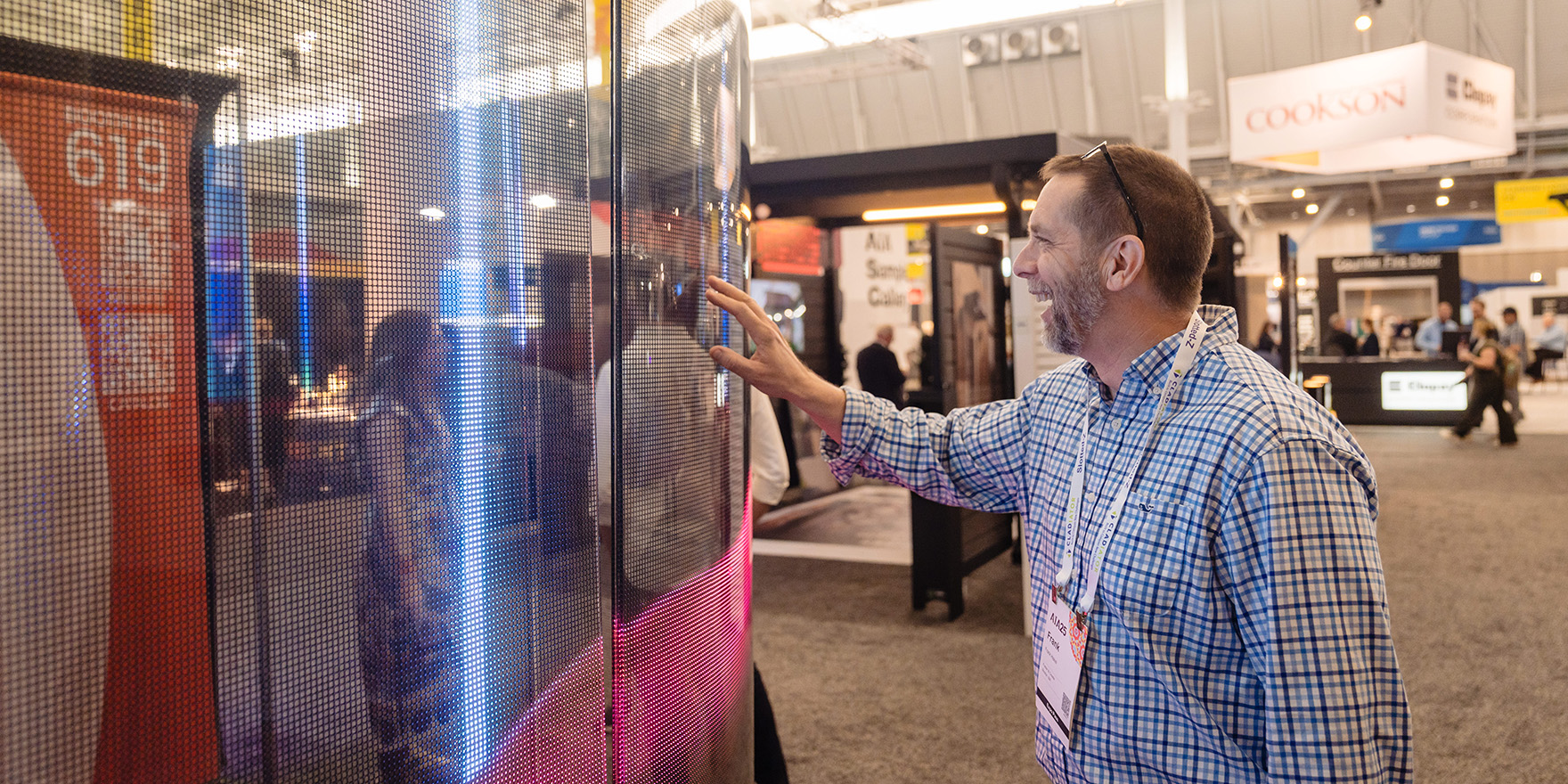 Man touching new building material on expo floor